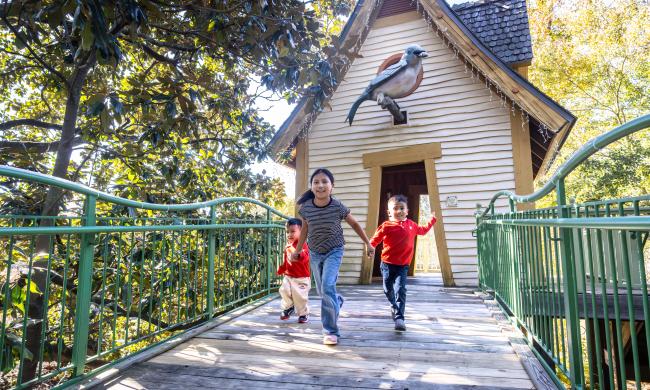 three children run towards camera playing at My Big Backyard