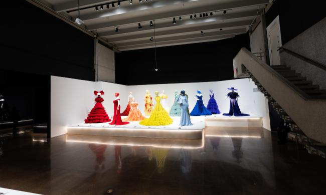 Exhibit showcasing colorful dresses at the Memphis Brooks Museum of Art.