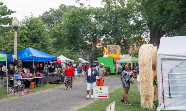 People stopping at vendors and booths at the Memphis Juneteenth Festival.