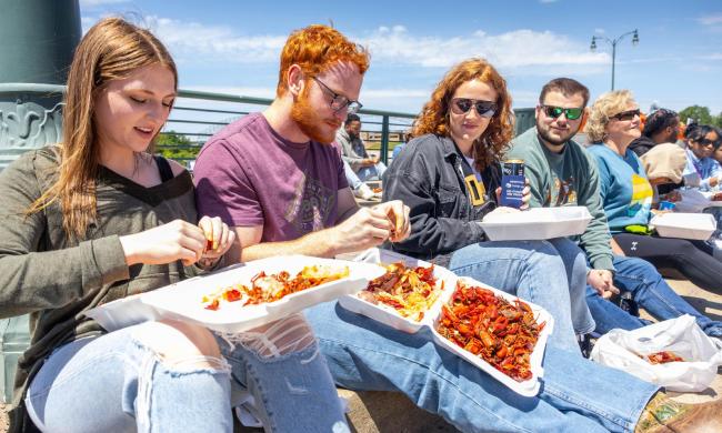 Friends dig into crawfish at Rajun Cajun Crawfish Festival.