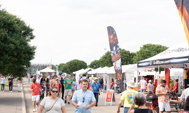 Guests walking past the booths at World Championship Barbecue Cooking Contest.