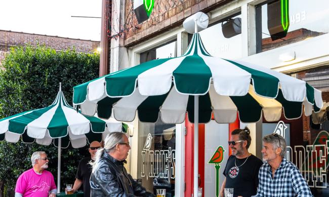 Birdies golf bar exterior entrance with people at patio tables
