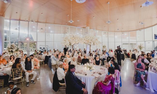people sitting at tables during wedding reception inside Beale Street Landing venue
