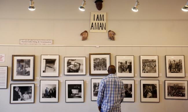 Man looking at photographs at the Withers Collection Museum &amp; Gallery.