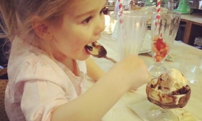 A child eats an ice-cream sundae at the Schwab Soda Fountain in Memphis
