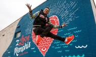 Lil Buck dancing in front of the I Love Memphis mural near Crosstown Concourse