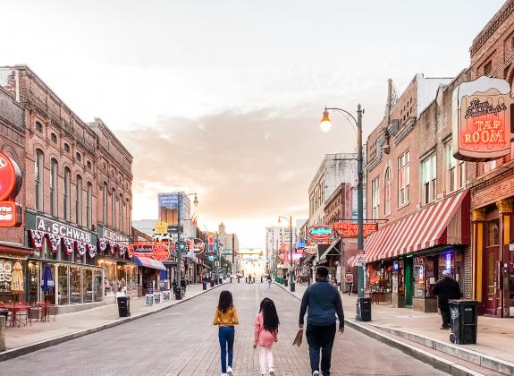 Family strolling Beale Street at sunset