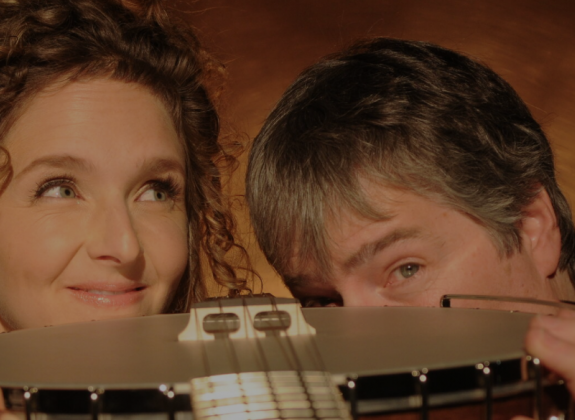 Bela and Abigail holding a banjo
