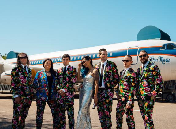 Wedding party poses in front of Elvis' private plane, the Lisa Marie