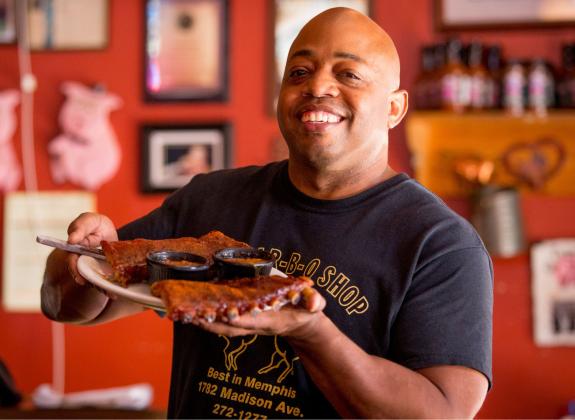 Owner Eric Vernon showcases a platter of ribs at his Midtown Memphis restaurant, The Bar-B-Q Shop