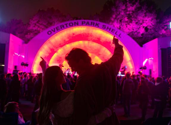 A couple stands together in front of Memphis' Overton Park Shell during a concert