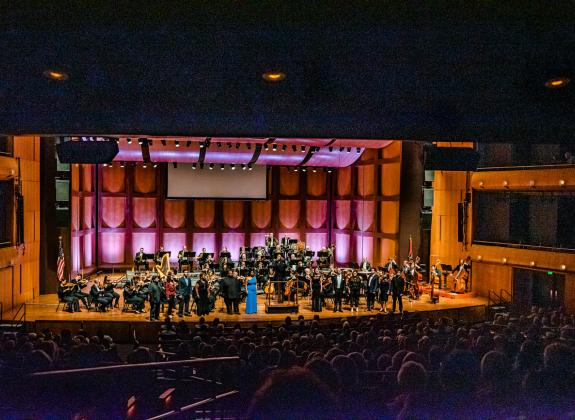 Orchestra on stage at the Cannon Center for the Performing Arts.
