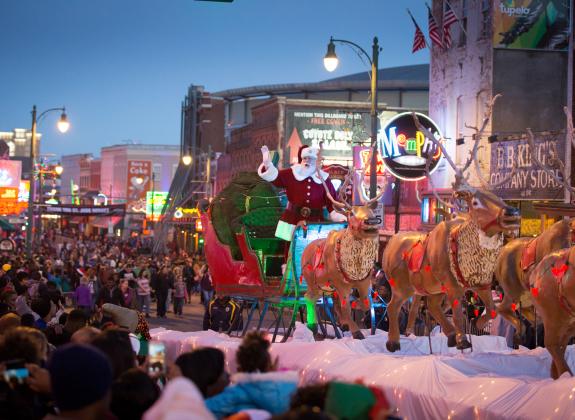 Santa riding his sleigh down Beale Street in the annual Beale St. holiday parade.