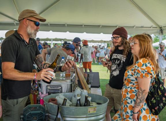 brewery rep pours samples for Brewfest patrons