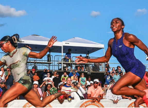 Two African American women running next to each other in a race