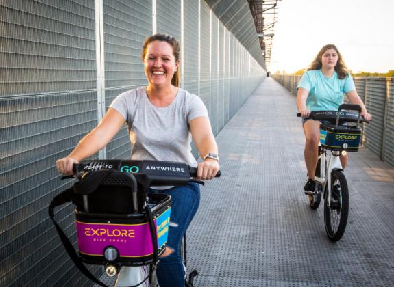 Woman using Explore Bike Share on Big River Crossing. Photo: Craig Thompson Photo