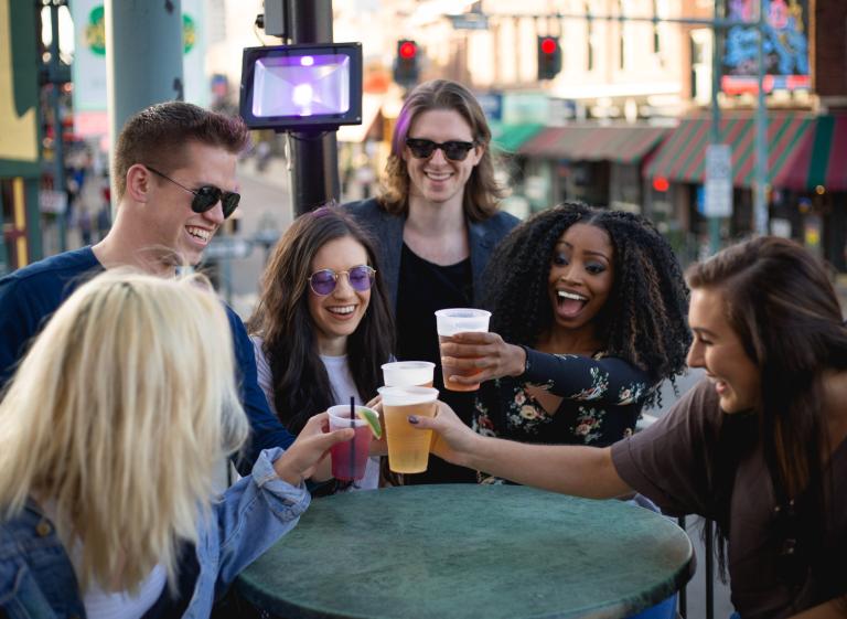 Friends cheersing on the rooftop patio at Alfred's on Beale. Photo