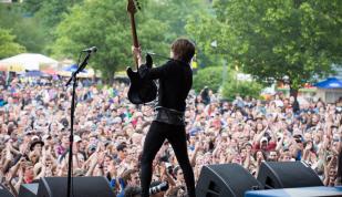Performer in front of massive crowds at Beale Street Music Festival.