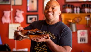 Owner Eric Vernon showcases a platter of ribs at his Midtown Memphis restaurant, The Bar-B-Q Shop