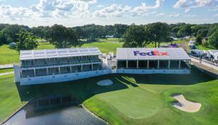 aerial shot of golf course with Fedex bleachers/booths next to hole