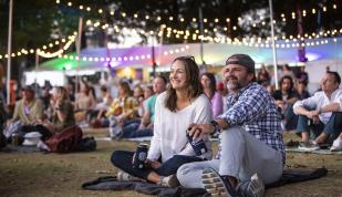 A couple sits on the lawn of Mempho Music Festival.
