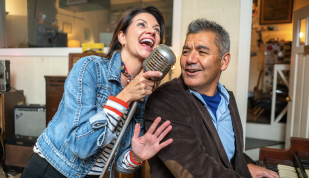 couple singing at sun studio into elvis mic
