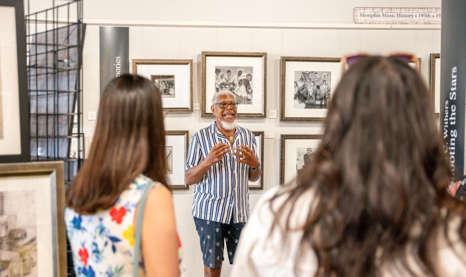 People listen to tour guide speak at Withers Collection Museum &amp; Gallery.
