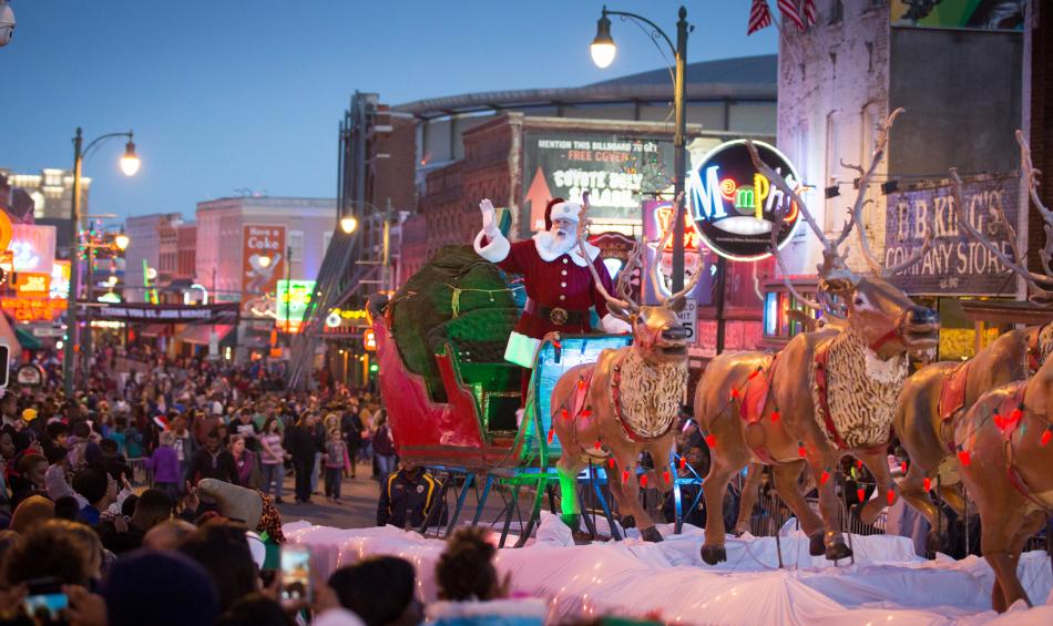 Santa riding his sleigh down Beale Street in the annual Beale St. holiday parade.