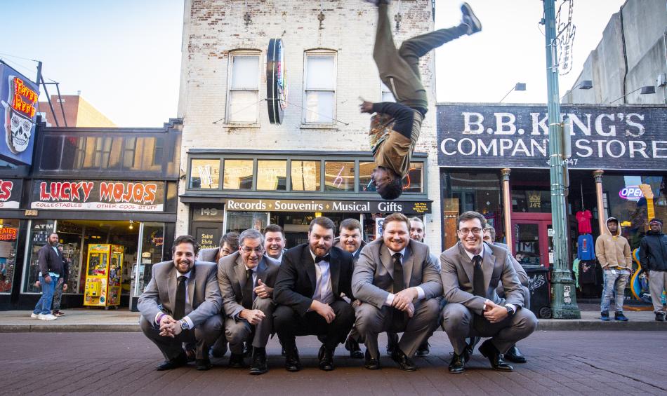 Beale Street flipper jumps upside down over grooms wedding party