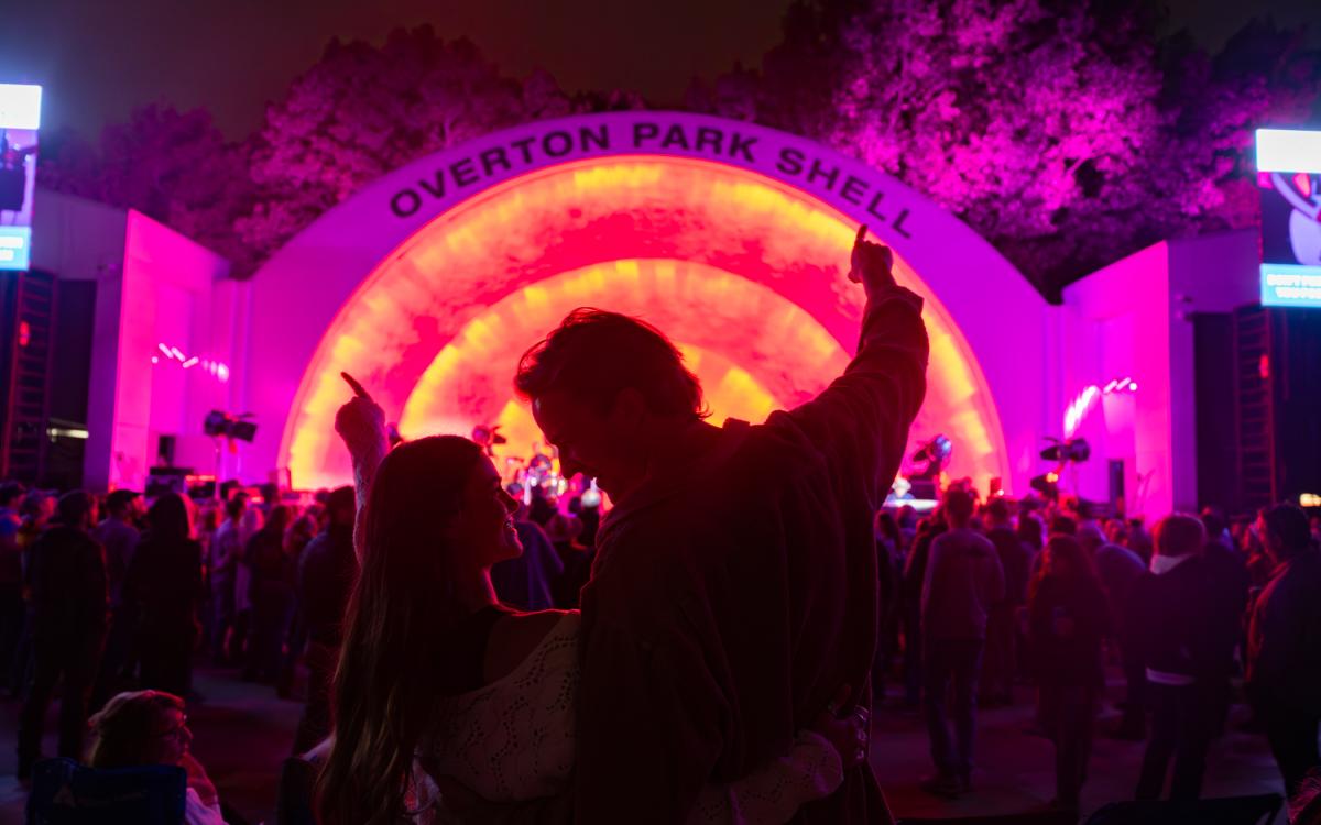 A couple stands together in front of Memphis' Overton Park Shell during a concert