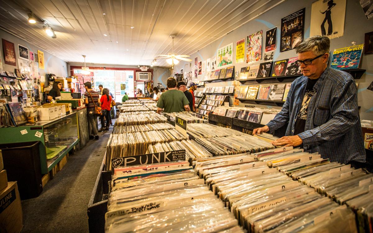 Shopping for records inside Goner Records in Memphis, TN