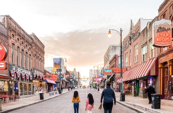 Family strolling Beale Street at sunset