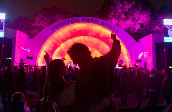 A couple stands together in front of Memphis' Overton Park Shell during a concert