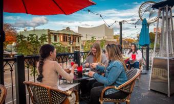 girls dining on lafayette's balcony patio