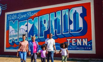 Multigenerational family in front Edge District Memphis mural | The Traveling Child