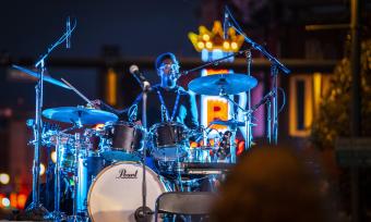 the PRVLG drums on Beale Street in front of neon B.B. King sign