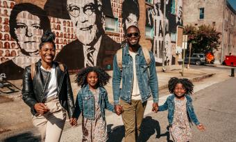 Family in front of National Civil Rights Museum mural  