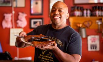 Owner Eric Vernon showcases a platter of ribs at his Midtown Memphis restaurant, The Bar-B-Q Shop