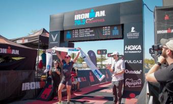 A competitor crosses the finish line of the St. Jude IRONMAN 70.3 Memphis