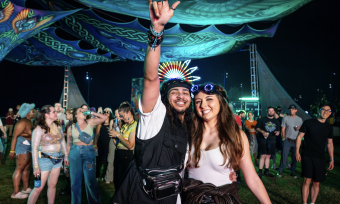 two people pose for photo at night during riverbeat