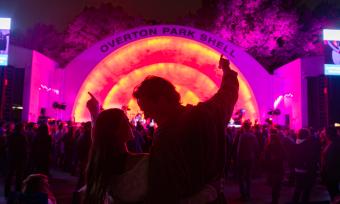 A couple stands together in front of Memphis' Overton Park Shell during a concert
