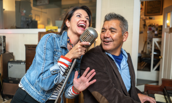 couple singing at sun studio into elvis mic