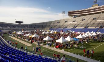 aerial photo of stadium filled with tents for chicken and beer festival