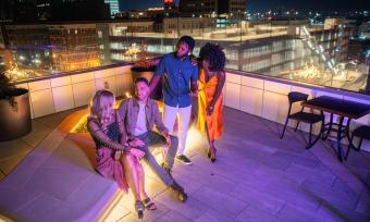 friends gathering around rooftop fire pit