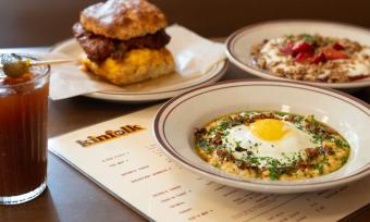 assortment of breakfast dishes: grits bowl, chicken biscuit sandwich over kinfolk menu