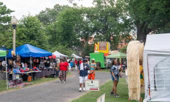 People stopping at vendors and booths at the Memphis Juneteenth Festival.